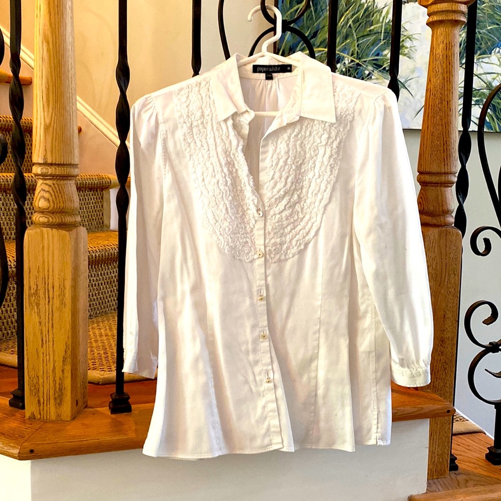 Paperwhite ruffled bib cotton blouse with delicate pearlized buttons